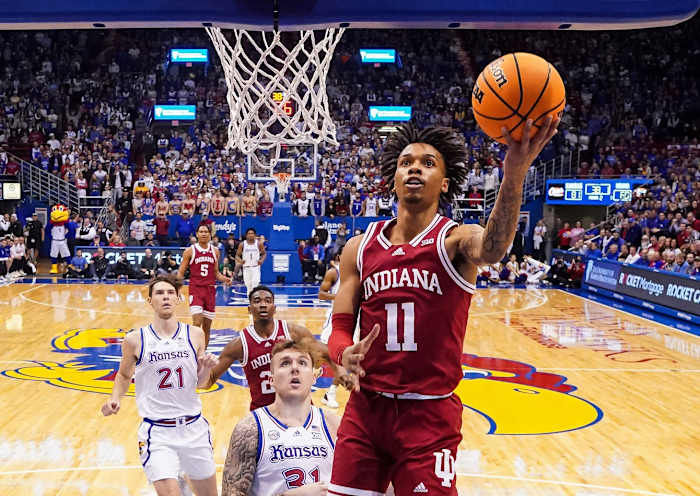 Indiana Hoosiers guard CJ Gunn (11) shoots a layup against Kansas Jayhawks forward Cam Martin (31) during the second half at Allen Fieldhouse.